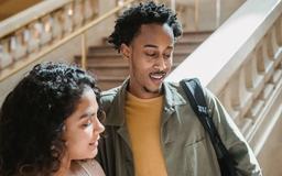Two students are looking at something together during a visit to a museum