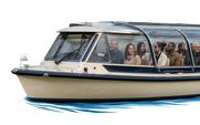 A covered tour boat with a group of passengers on board.